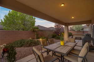 Fenced backyard with a patio area, outdoor dining area, and area for grilling