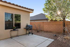 View of patio featuring a grill