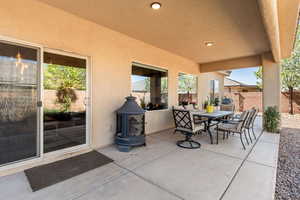 Fenced backyard with outdoor dining area and a patio