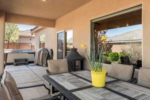View of patio / terrace featuring a hot tub and outdoor dining area