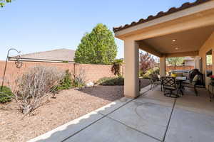 Fenced backyard featuring a patio and outdoor dining space
