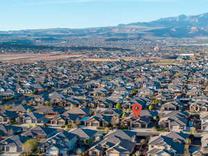Aerial view of property's location featuring a mountain backdrop and nearby suburban area