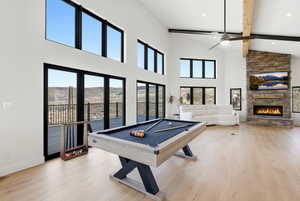 Recreation room with pool table, light wood-type flooring, ceiling fan, a fireplace, and recessed lighting