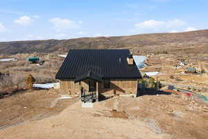 View of outdoor structure with a mountain and lake views and large flat lot area