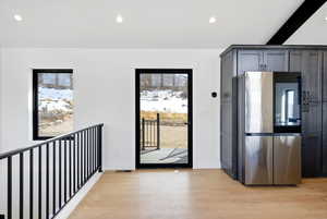 Kitchen featuring smart refrigerator, light wood-type flooring, beam ceiling, and recessed lighting