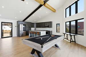 Game room featuring plenty of natural light, pool table, light wood finished floors, lofted ceiling, and recessed lighting