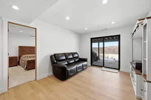 Living area with a mountain view, light wood-style floors, and recessed lighting