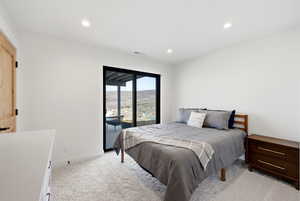 Bedroom featuring access to outside, light colored carpet, and recessed lighting