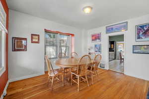 Dining area with light wood-type flooring and baseboards