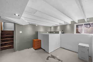 Basement featuring stairway and recessed lighting
