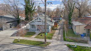 View of front of house with a residential view, a fenced front yard, and driveway