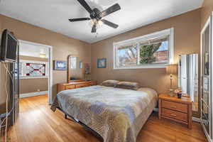 Bedroom with light wood finished floors and ceiling fan