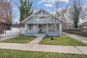 View of front of property featuring covered porch and a chimney