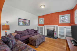 Living room with wood finished floors and a fireplace