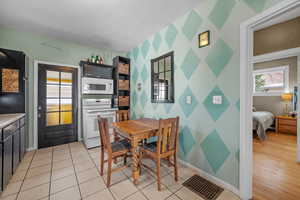 Dining room with an accent wall and wallpapered walls