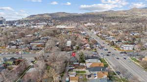 Aerial view of property and surrounding area with a mountainous background