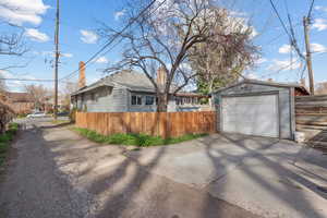 View of side of home with a garage and driveway