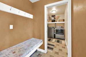 Laundry area with washer and dryer and light floors