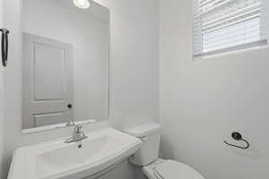 1/2 Bathroom featuring toilet and a sink