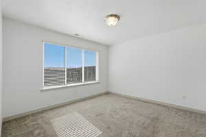 Bedroom with light colored carpet
