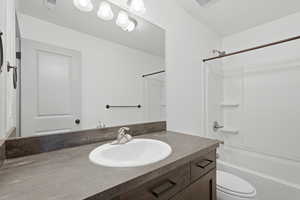 Bathroom featuring vanity and shower / tub combination
