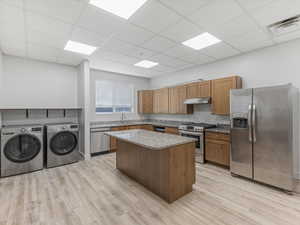 Full kitchen featuring wood cabinetry, stainless steel appliances, and granite countertops