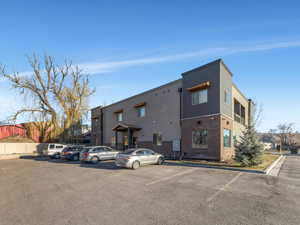 View of property with uncovered parking