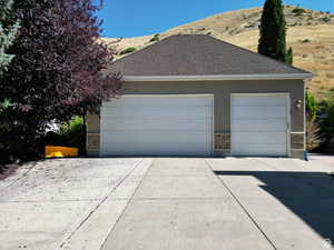 Garage with driveway and a mountain view