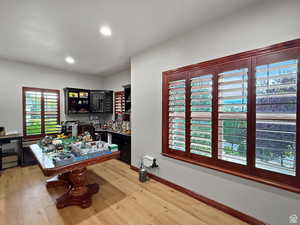 Office area with light wood finished floors, and recessed lighting