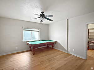Basement Bedroom, light wood-type flooring, and a ceiling fan