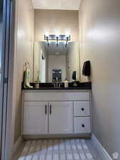 Half Bathroom featuring baseboards and vanity