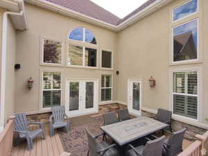 Wooden terrace featuring french doors and outdoor dining area