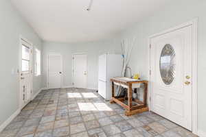 Mudroom with laundry. Entrances to Front yard, Backyard, Garage and then Kitchen.