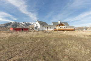 Rear view of house with a chimney and a mountain view