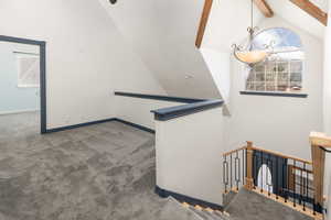 Staircase with beam ceiling and carpet