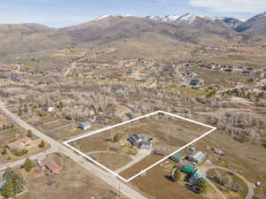 Aerial view of property and surrounding area with property boundaries highlighted and nearby suburban area
