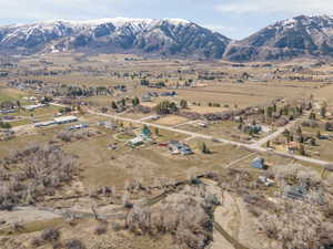 Aerial overview of property's location with rural landscape and a mountain backdrop