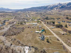Aerial view of property's location with a mountain backdrop and rural landscape