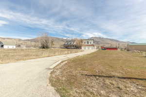View of asphalt driveway featuring a mountain view