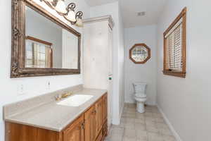 Primary Bathroom with toilet and vanity