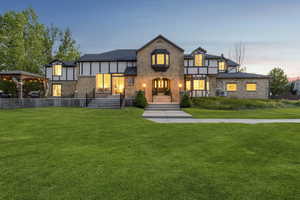 Tudor house with a lawn and brick siding