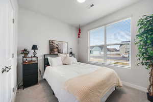 Carpeted bedroom with baseboards