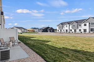 View of grassy yard featuring a residential view and a patio area