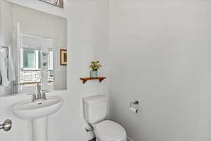 Bathroom featuring toilet and baseboards