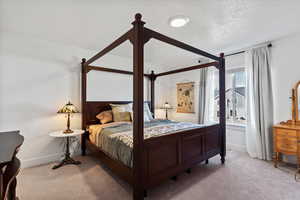 Carpeted bedroom featuring baseboards