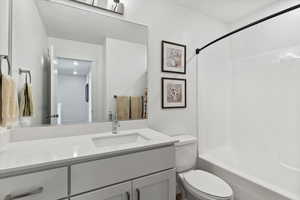Bathroom featuring vanity and shower / washtub combination