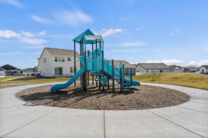 Community jungle gym with a residential view and a yard