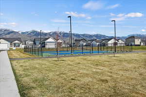 View of home's community featuring a tennis court, a residential view, and a mountain view