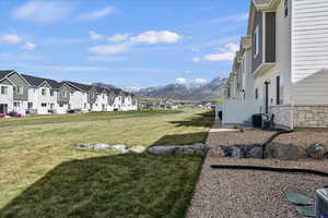 View of grassy yard featuring a mountain view