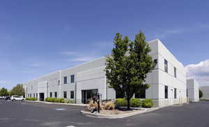 View of building exterior with uncovered parking